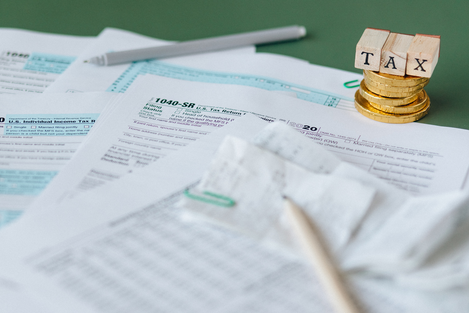 Tax Documents with Pens on Top of a Table